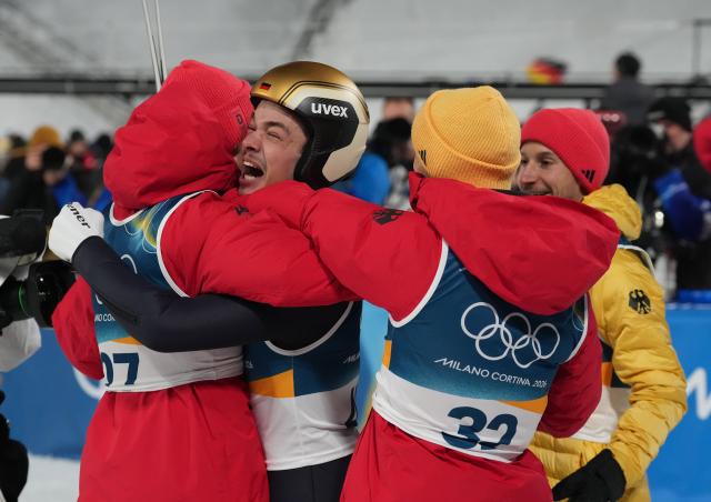 (260210) -- PREDAZZO, Feb. 10, 2026 (Xinhua) -- Philipp Raimund (2nd L) of Germany celebrates winning the gold medal with his teammates Felix Hoffmann (1st R), Pius Paschke (2nd R) and Andreas Wellinger during the Ski Jumping Men's Normal Hill Individual of the 2026 Milan-Cortina Winter Olympics in Predazzo, Italy, Feb. 9, 2026. (Xinhua/Meng Yongmin)