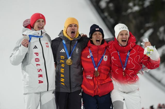 (260210) -- PREDAZZO, Feb. 10, 2026 (Xinhua) -- Gold medallist Philipp Raimund of Germany (2nd L), silver medalist Kacper Tomasiak of Poland (1st L), bronze medalists Nikaido Ren (2nd R) of Japan and Gregor Deschwanden of Switzerland pose for photos during the awarding ceremony for the Ski Jumping Men's Normal Hill Individual of the 2026 Milan-Cortina Winter Olympics in Predazzo, Italy, Feb. 9, 2026. (Xinhua/Meng Yongmin)
