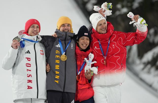 (260210) -- PREDAZZO, Feb. 10, 2026 (Xinhua) -- Gold medallist Philipp Raimund of Germany (2nd L), silver medalist Kacper Tomasiak of Poland (1st L), bronze medalists Nikaido Ren (2nd R) of Japan and Gregor Deschwanden of Switzerland pose for photos during the awarding ceremony for the Ski Jumping Men's Normal Hill Individual of the 2026 Milan-Cortina Winter Olympics in Predazzo, Italy, Feb. 9, 2026. (Xinhua/Meng Yongmin)