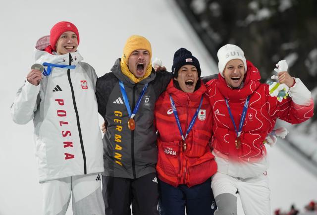 (260210) -- PREDAZZO, Feb. 10, 2026 (Xinhua) -- Gold medallist Philipp Raimund of Germany (2nd L), silver medalist Kacper Tomasiak of Poland (1st L), bronze medalists Nikaido Ren (2nd R) of Japan and Gregor Deschwanden of Switzerland pose for photos during the awarding ceremony for the Ski Jumping Men's Normal Hill Individual of the 2026 Milan-Cortina Winter Olympics in Predazzo, Italy, Feb. 9, 2026. (Xinhua/Meng Yongmin)