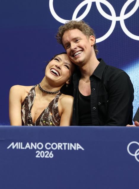 (260210) -- MILAN, Feb. 10, 2026 (Xinhua) -- Madison Chock (L)/Evan Bates of the United States react after performing during the rhythm dance of figure skating ice dance competition at the Milan-Cortina 2026 Olympic Winter Games in Milan, Italy, Feb. 9, 2026. (Xinhua/Chen Yichen)