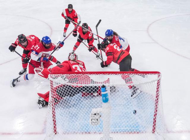 (260210) -- MILAN, Feb. 10, 2026 (Xinhua) -- Mlynkova Natalie (1st R) of the Czech Republic shoots to score during the ice hockey women's preliminary round group A match between Canada and the Czech Republic at the Milan-Cortina 2026 Olympic Winter Games in Milan, Italy, Feb. 9, 2026. (Xinhua/Sun Fei)