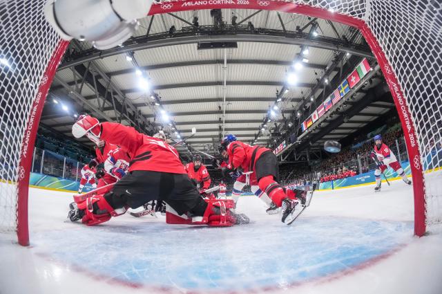(260210) -- MILAN, Feb. 10, 2026 (Xinhua) -- Goalkeeper Ann-Renee Desbiens (front L) of Canada fails to save a goal during the ice hockey women's preliminary round group A match between Canada and the Czech Republic at the Milan-Cortina 2026 Olympic Winter Games in Milan, Italy, Feb. 9, 2026. (Sun Fei/Pool via Xinhua)
