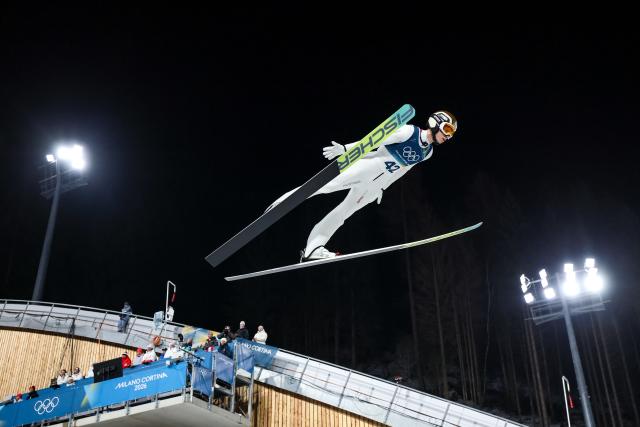 (260210) -- PREDAZZO, Feb. 10, 2026 (Xinhua) -- Stephan Embacher of Austria competes during the Ski Jumping Men's Normal Hill Individual of the 2026 Milan-Cortina Winter Olympics in Predazzo, Italy, Feb. 9, 2026. (Xinhua/Huang Wei)