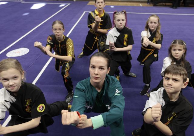 (260210) -- BUDAPEST, Feb. 10, 2026 (Xinhua) -- Viktoria Simon (C, front), coach of the Hungarian Wushu Team, poses for a photo with her team members during a Wushu training camp in Budapest, Hungary, on Feb. 8, 2026. TO GO WITH 'Feature: Europe's young Wushu athletes sharpen skills as Youth Olympic debut nears' (Photo by Laszlo Balogh/Xinhua)