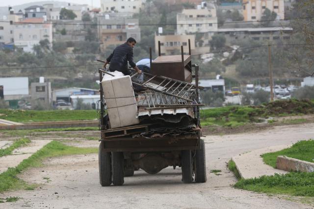 (260210) -- JENIN, Feb. 10, 2026 (Xinhua) -- Palestinians leave with their belongings after Israeli forces forced them to evacuate their homes in the town of Arraba, south of Jenin city in the West Bank, on Feb. 9, 2026. Israel's recent decisions to deepen control over the West Bank and expand Jewish settlements there have raised broad Palestinian concerns over potential land confiscation and threats to regional stability. (Photo by Nidal Eshtayeh/Xinhua)