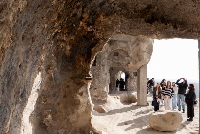 (260210) -- GORI, Feb. 10, 2026 (Xinhua) -- People visit the ruins of the Uplistsikhe rock-hewn city near Gori, Georgia, on Jan. 30, 2026. The Uplistsikhe rock-hewn city ruins is located on a high rocky hill on the bank of the Kura River near Gori in Georgia. It has been on the UNESCO World Heritage Tentative List since 2007. (Xinhua/Chen Junfeng)