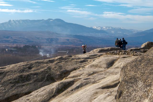 (260210) -- GORI, Feb. 10, 2026 (Xinhua) -- People visit the ruins of the Uplistsikhe rock-hewn city near Gori, Georgia, on Jan. 30, 2026. The Uplistsikhe rock-hewn city ruins is located on a high rocky hill on the bank of the Kura River near Gori in Georgia. It has been on the UNESCO World Heritage Tentative List since 2007. (Xinhua/Chen Junfeng)