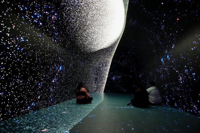 (260210) -- SYDNEY, Feb. 10, 2026 (Xinhua) -- People enjoy a space-themed immersive digital experience exhibition at DigiPark Sydney in Sydney, Australia, Feb. 10, 2026. The DigiPark Sydney launched an immersive digital experience exhibition on traditional Chinese cultures, which is supported by holographic digital display technology. (Xinhua/Ma Ping)