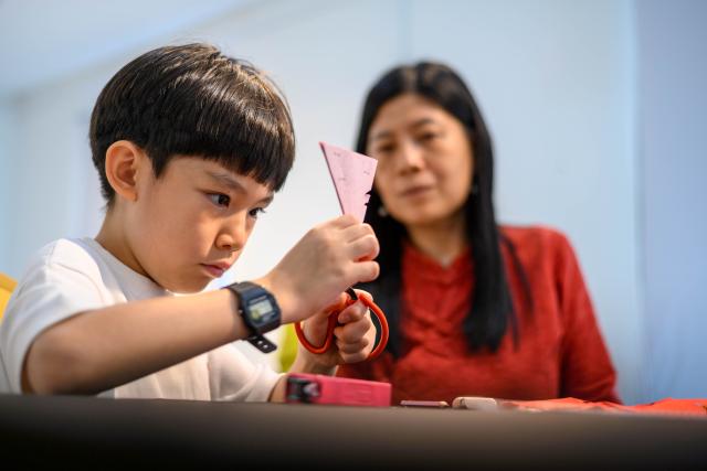 (260210) -- KUALA LUMPUR, Feb. 10, 2026 (Xinhua) -- A child tries paper-cutting in Kuala Lumpur, Malaysia, Feb. 7, 2026. As the Spring Festival approaches, traditional Chinese art of paper-cutting featuring the Year of the Horse increased the festive atmosphere in Malaysia. (Photo by Chong Voon Chung/Xinhua)