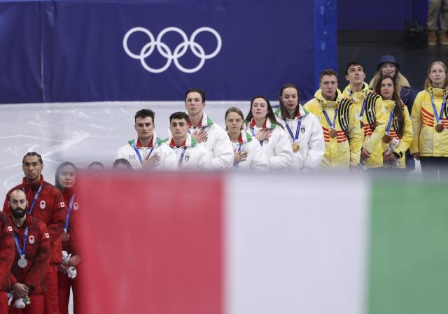 (260210) -- MILAN, Feb. 10, 2026 (Xinhua) -- Gold medalists team Italy sing national anthem during the awarding ceremony for the short track speed skating mixed team relay at the Milan-Cortina 2026 Olympic Winter Games in Milan, Italy, Feb. 10, 2026. (Xinhua/Chen Yichen)