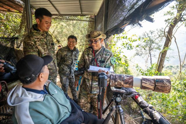 (260210) -- YINGJIANG, Feb. 10, 2026 (Xinhua) -- Members of the "Hornbill Patrol Team" chat with a tourist at a hornbill watching spot in Shiti Village, Yingjiang County, southwest China's Yunnan Province, Feb. 6, 2026. In Yunnan Tongbiguan provincial nature reserve, hornbills, a species under first-class state protection in China, are in a critical period of breeding preparation. Members of the "Hornbill Patrol Team" conduct regular patrols to ensure their safety during the breeding season.
   The "Hornbill Patrol Team" is composed of local villagers and forest rangers. Since its establishment in 2021, the team has grown to 26 members. Apart from patrolling, many of them also work as bird-watching guides or are involved in the ecological industry, achieving a positive interaction between ecological conservation and community development. (Xinhua/Gao Yongwei)