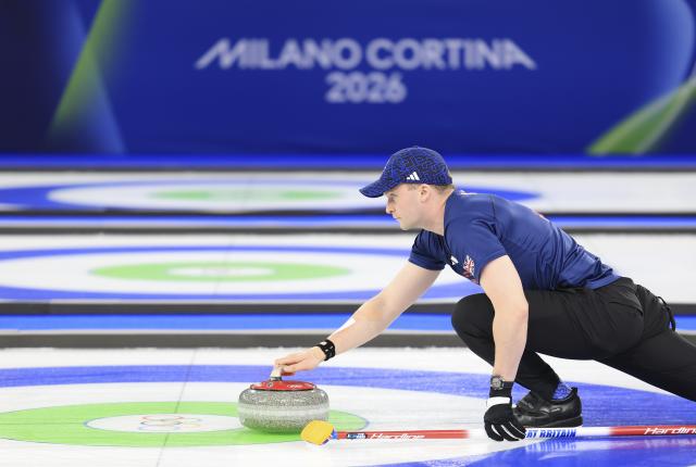 (260210) -- CORTINA D'AMPEZZO, Feb. 10, 2026 (Xinhua) -- Bruce Mouat of Britain competes during the curling mixed doubles bronze medal match between Britain and Italy at the Milan-Cortina 2026 Olympic Winter Games in Cortina, Italy, Feb. 10, 2026. (Xinhua/Ding Xu)