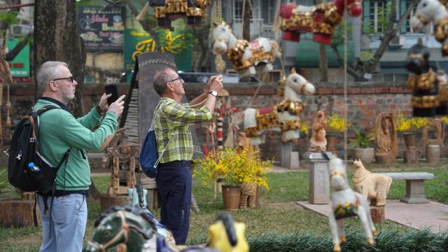 (260210) -- HANOI, Feb. 10, 2026 (Xinhua) -- Tourists visit an exhibition themed on horses at the Temple of Literature in Hanoi, Vietnam, Jan. 29, 2026. TO GO WITH "Feature: Horse imagery fills Vietnamese festive spaces as Lunar New Year approaches" (Xinhua/Hu Jiali)