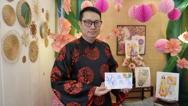 (260210) -- HANOI, Feb. 10, 2026 (Xinhua) -- Nguyen Quang Vinh, designer of a special Lunar New Year horse stamp collection, shows the stamps he created in Hanoi, Vietnam, Feb. 4, 2026. TO GO WITH "Feature: Horse imagery fills Vietnamese festive spaces as Lunar New Year approaches" (Xinhua/Liu Ying)