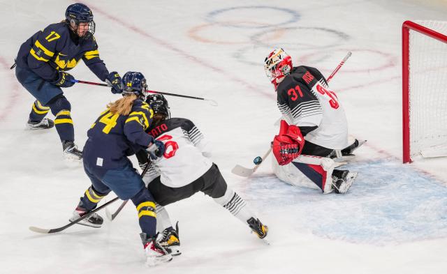 (260210) -- MILAN, Feb. 10, 2026 (Xinhua) -- Kawaguchi Riko (R) of Japan saves a goal during the ice hockey women's preliminary round group B match between Sweden and Japan at the Milan-Cortina 2026 Olympic Winter Games in Milan, Italy, Feb. 10, 2026. (Xinhua/Sun Fei)