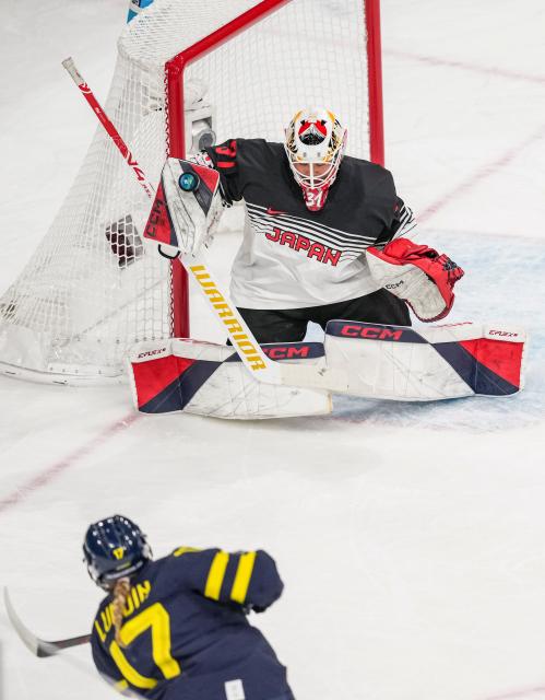 (260210) -- MILAN, Feb. 10, 2026 (Xinhua) -- Kawaguchi Riko (Top) of Japan saves a goal during the ice hockey women's preliminary round group B match between Sweden and Japan at the Milan-Cortina 2026 Olympic Winter Games in Milan, Italy, Feb. 10, 2026. (Xinhua/Sun Fei)