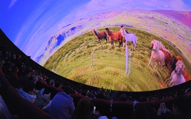 (260210) -- SHANGHAI, Feb. 10, 2026 (Xinhua) -- Visitors view a horse-themed concert, which is a part of the Galloping Wonders: Year of the Horse Science & Culture Exhibition, at a planetarium of Shanghai Science & Technology Museum in east China's Shanghai, Feb. 10, 2026. Jointly hosted by Shanghai Science & Technology Museum and the Palace Museum, the exhibition kicked off here on Tuesday. (Xinhua/Fang Zhe)
