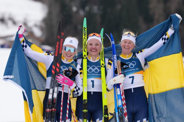 (260210) -- TESERO, Feb. 10, 2026 (Xinhua) -- Gold medalist Linn Svahn (C) of Sweden, silver medalist Jonna Sundling (L) of Sweden and bronze medalist Maja Dahlqvist of Sweden pose for photos after the cross-country skiing women's sprint classic final at the Milano Cortina 2026 Olympic Winter Games in Tesero, Italy, Feb. 10, 2026. (Xinhua/Peng Ziyang)