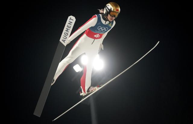 (260210) -- PREDAZZO, Feb. 10, 2026 (Xinhua) -- Zeng Ping of China competes during the ski jumping mixed team match at the Milan-Cortina 2026 Olympic Winter Games in Predazzo, Italy, Feb. 10, 2026. (Xinhua/Meng Yongmin)