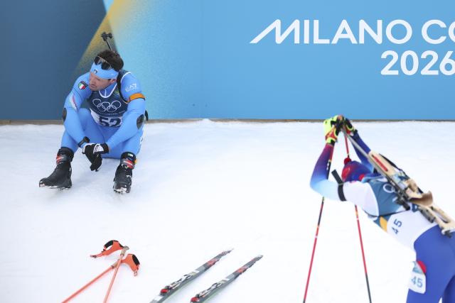 (260210) -- ANTERSELVA, Feb. 10, 2026 (Xinhua) -- Tommaso Giacomel (L) of Italy reacts after the biathlon men's 20km individual at the Milan-Cortina 2026 Olympic Winter Games in Anterselva, Italy, Feb. 10, 2026. (Xinhua/Zhang Tao)