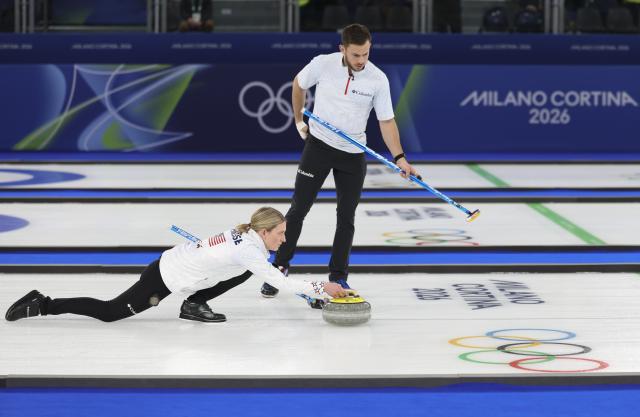 (260210) -- CORTINA D'AMPEZZO, Feb. 10, 2026 (Xinhua) -- Cory Thiesse (L) and Korey Dropkin of the United States competes during the curling mixed doubles gold medal match between Sweden and the United States at the Milan-Cortina 2026 Olympic Winter Games in Cortina, Italy, Feb. 10, 2026. (Xinhua/Ding Xu)