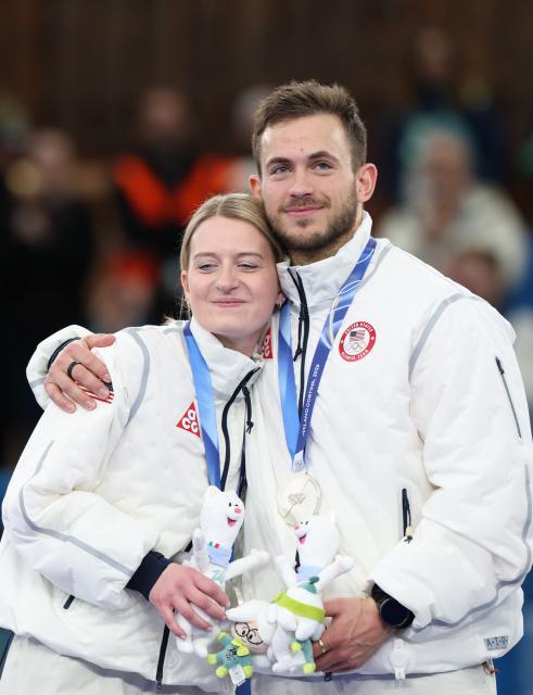 (260210) -- CORTINA D'AMPEZZO, Feb. 10, 2026 (Xinhua) -- Korey Dropkin (R) of the United States hugs his teammate Cory Thiesse during the awarding ceremony of the curling mixed doubles at the Milan-Cortina 2026 Olympic Winter Games in Cortina, Italy, Feb. 10, 2026. (Xinhua/Ding Xu)