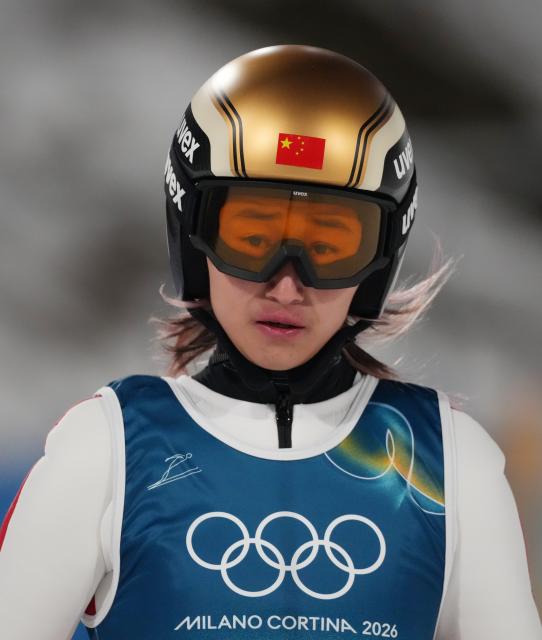 (260210) -- PREDAZZO, Feb. 10, 2026 (Xinhua) -- Zeng Ping of China reacts during the ski jumping mixed team final round match at the Milan-Cortina 2026 Olympic Winter Games in Predazzo, Italy, Feb. 10, 2026. (Xinhua/Huang Wei)