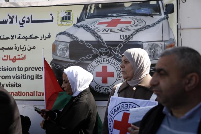 (260210) -- HEBRON, Feb. 10, 2026 (Xinhua) -- Palestinians and activists take part in a protest in front of the International Committee of the Red Cross (ICRC) office in Hebron City in the West Bank, on Feb. 10, 2026. Protesters condemned Israel for blocking the Red Cross's humanitarian work and called on the international community to uphold international law and ensure the ICRC's free operation. (Photo by Mamoun Wazwaz/Xinhua)