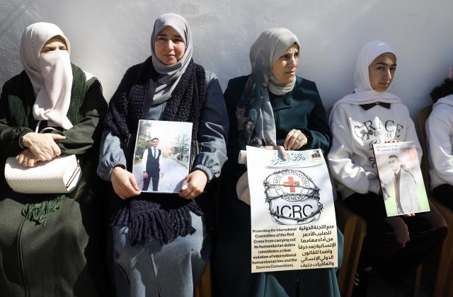 (260210) -- HEBRON, Feb. 10, 2026 (Xinhua) -- Palestinians and activists take part in a protest in front of the International Committee of the Red Cross (ICRC) office in Hebron City in the West Bank, on Feb. 10, 2026. Protesters condemned Israel for blocking the Red Cross's humanitarian work and called on the international community to uphold international law and ensure the ICRC's free operation. (Photo by Mamoun Wazwaz/Xinhua)