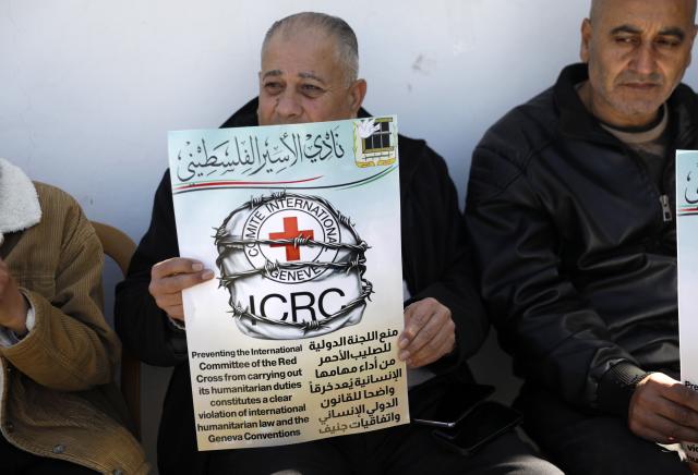 (260210) -- HEBRON, Feb. 10, 2026 (Xinhua) -- Palestinians and activists take part in a protest in front of the International Committee of the Red Cross (ICRC) office in Hebron City in the West Bank, on Feb. 10, 2026. Protesters condemned Israel for blocking the Red Cross's humanitarian work and called on the international community to uphold international law and ensure the ICRC's free operation. (Photo by Mamoun Wazwaz/Xinhua)