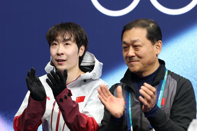 (260210) -- MILAN, Feb. 10, 2026 (Xinhua) -- Jin Boyang (L) of China waits for his score during the short program competition of figure skating men single skating at the Milan-Cortina 2026 Olympic Winter Games in Milan, Italy, Feb. 10, 2026. (Xinhua/Li Ming)