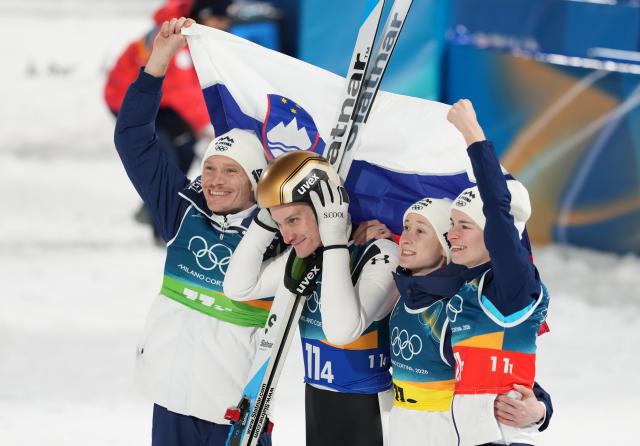 (260210) -- PREDAZZO, Feb. 10, 2026 (Xinhua) -- Anze Lanisek, Domen Prevc, Nika Prevc and Nika Vodan (L to R) of Slovenia celebrate after winning the ski jumping mixed team match at the Milan-Cortina 2026 Olympic Winter Games in Predazzo, Italy, Feb. 10, 2026. (Xinhua/Meng Yongmin)