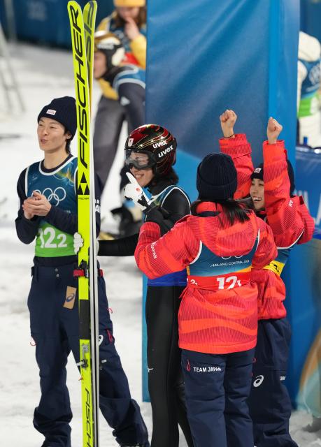 (260210) -- PREDAZZO, Feb. 10, 2026 (Xinhua) -- Athletes of Japan celebrate after the ski jumping mixed team match at the Milan-Cortina 2026 Olympic Winter Games in Predazzo, Italy, Feb. 10, 2026. (Xinhua/Meng Yongmin)