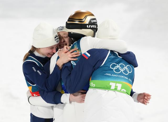 (260210) -- PREDAZZO, Feb. 10, 2026 (Xinhua) -- Athletes of Slovenia celebrate after winning the ski jumping mixed team match at the Milan-Cortina 2026 Olympic Winter Games in Predazzo, Italy, Feb. 10, 2026. (Xinhua/Meng Yongmin)
