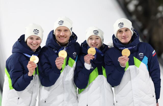 (260210) -- PREDAZZO, Feb. 10, 2026 (Xinhua) -- Gold medalists Anze Lanisek, Domen Prevc, Nika Prevc and Nika Vodan of Slovenia pose for a photo during the awarding ceremony of the ski jumping mixed team match at the Milan-Cortina 2026 Olympic Winter Games in Predazzo, Italy, Feb. 10, 2026. (Xinhua/Huang Wei)