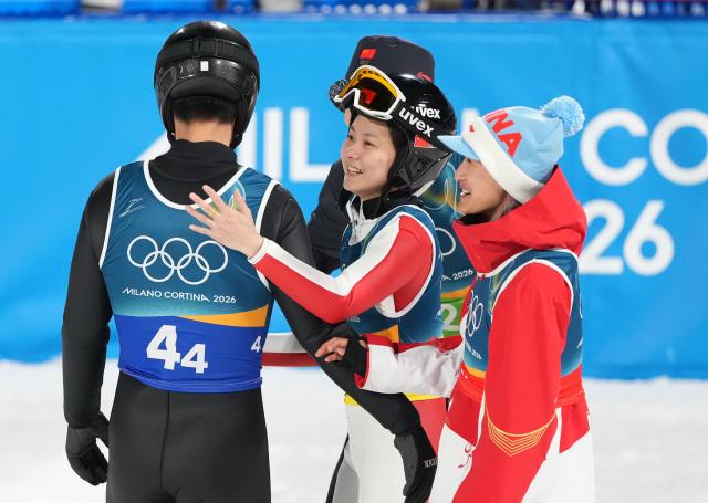 (260210) -- PREDAZZO, Feb. 10, 2026 (Xinhua) -- Athletes of China react after the ski jumping mixed team match at the Milan-Cortina 2026 Olympic Winter Games in Predazzo, Italy, Feb. 10, 2026. (Xinhua/Meng Yongmin)