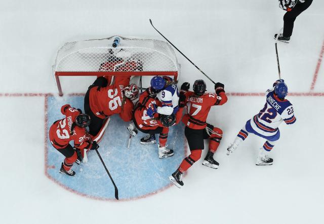 (260210) -- MILAN, Feb. 10, 2026 (Xinhua) -- Players vies for the puck during the ice hockey women's preliminary round group A match between Canada and the United States at the Milan-Cortina 2026 Olympic Winter Games in Milan, Italy, Feb. 10, 2026. (Xinhua/Zhang Haofu)