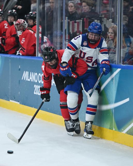 (260210) -- MILAN, Feb. 10, 2026 (Xinhua) -- Kati Tabin (L) of Canada vies with Grace Zumwinkle of the United States during the ice hockey women's preliminary round group A match between Canada and the United States at the Milan-Cortina 2026 Olympic Winter Games in Milan, Italy, Feb. 10, 2026. (Xinhua/Zhang Haofu)