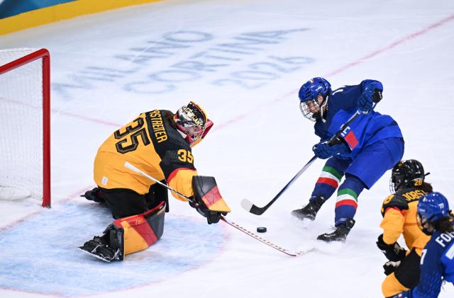 (260210) -- MILAN, Feb. 10, 2026 (Xinhua) -- Goalkeeper Sandra Abstreiter (L) of Germany defends during the ice hockey women's preliminary round group B match between Germany and Italy of the Milan-Cortina 2026 Olympic Winter Games in Milan, Italy, Feb. 10, 2026. (Xinhua/Tao Xiyi)