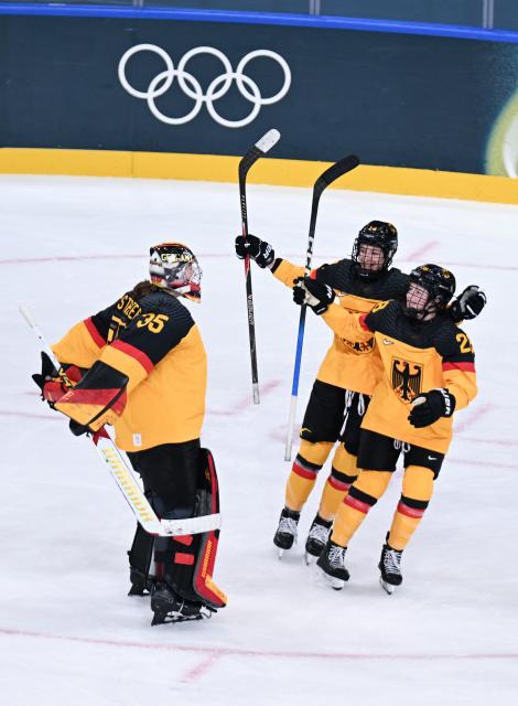 (260211) -- MILAN, Feb. 11, 2026 (Xinhua) -- Goalkeeper Sandra Abstreiter (L) of Germany celebrates victory after the ice hockey women's preliminary round group B match between Germany and Italy of the Milan-Cortina 2026 Olympic Winter Games in Milan, Italy, Feb. 10, 2026. (Xinhua/Tao Xiyi)