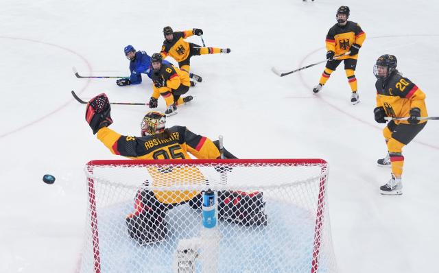 (260211) -- MILAN, Feb. 11, 2026 (Xinhua) -- Goalkeeper Sandra Abstreiter (front L) of Germany saves during the ice hockey women's preliminary round group B match between Germany and Italy of the Milan-Cortina 2026 Olympic Winter Games in Milan, Italy, Feb. 10, 2026. (Xinhua/Wang Kaiyan)