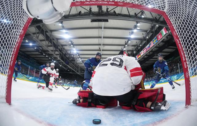 (260211) -- MILAN, Feb. 11, 2026 (Xinhua) -- Switzerland's goalkeeper Saskia Maurer (front) fails to save a shot during the ice hockey women's preliminary round group A match between Finland and Switzerland of the Milan-Cortina 2026 Olympic Winter Games in Milan, Italy, Feb. 10, 2026. (Xinhua/Wang Kaiyan)