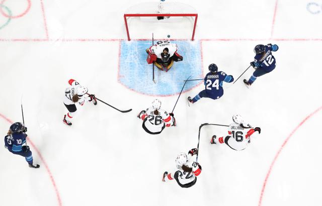 (260211) -- MILAN, Feb. 11, 2026 (Xinhua) -- Switzerland's goalkeeper Saskia Maurer (top) fails to save a shot during the ice hockey women's preliminary round group A match between Finland and Switzerland of the Milan-Cortina 2026 Olympic Winter Games in Milan, Italy, Feb. 10, 2026. (Xinhua/Wang Kaiyan)