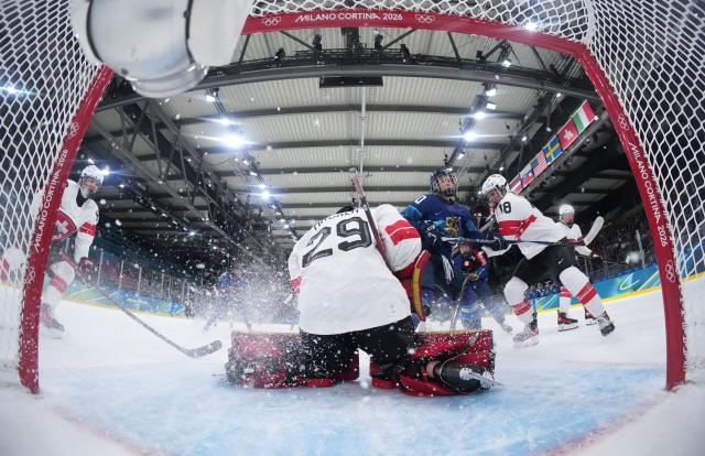 (260211) -- MILAN, Feb. 11, 2026 (Xinhua) -- Switzerland's goalkeeper Saskia Maurer (front) saves a shot during the ice hockey women's preliminary round group A match between Finland and Switzerland of the Milan-Cortina 2026 Olympic Winter Games in Milan, Italy, Feb. 10, 2026. (Xinhua/Wang Kaiyan)