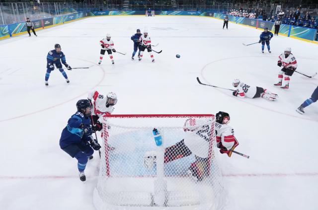 (260211) -- MILAN, Feb. 11, 2026 (Xinhua) -- Players of both teams compete during the ice hockey women's preliminary round group A match between Finland and Switzerland of the Milan-Cortina 2026 Olympic Winter Games in Milan, Italy, Feb. 10, 2026. (Xinhua/Wang Kaiyan)