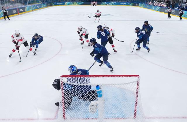 (260211) -- MILAN, Feb. 11, 2026 (Xinhua) -- Players of both teams compete during the ice hockey women's preliminary round group A match between Finland and Switzerland of the Milan-Cortina 2026 Olympic Winter Games in Milan, Italy, Feb. 10, 2026. (Xinhua/Wang Kaiyan)