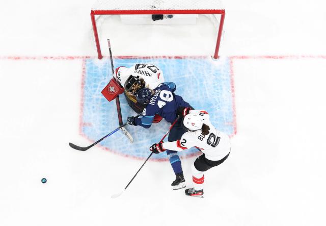 (260211) -- MILAN, Feb. 11, 2026 (Xinhua) -- Jenniina Nylund (C) of Finland tries to shoot during the ice hockey women's preliminary round group A match between Finland and Switzerland of the Milan-Cortina 2026 Olympic Winter Games in Milan, Italy, Feb. 10, 2026. (Xinhua/Wang Kaiyan)
