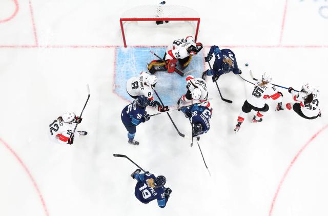 (260211) -- MILAN, Feb. 11, 2026 (Xinhua) -- Players of both teams compete during the ice hockey women's preliminary round group A match between Finland and Switzerland of the Milan-Cortina 2026 Olympic Winter Games in Milan, Italy, Feb. 10, 2026. (Xinhua/Wang Kaiyan)