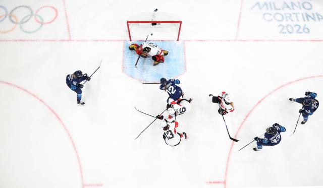 (260211) -- MILAN, Feb. 11, 2026 (Xinhua) -- Switzerland's goalkeeper Saskia Maurer (top) fails to save a shot during the ice hockey women's preliminary round group A match between Finland and Switzerland of the Milan-Cortina 2026 Olympic Winter Games in Milan, Italy, Feb. 10, 2026. (Xinhua/Wang Kaiyan)